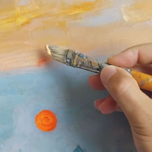 Hand-painting gesture, brush application of paint on canvas